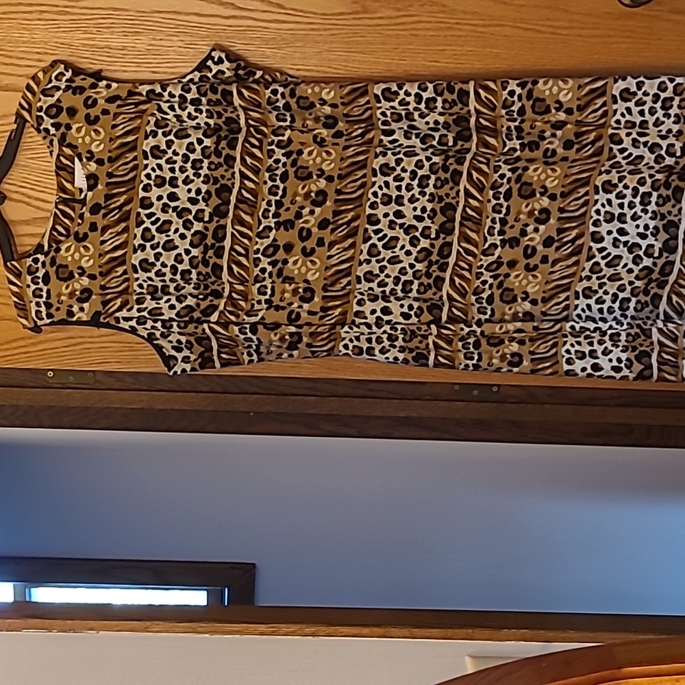 Animal print sleeveless midi dress. Pearl buttons on left side with small slit.
